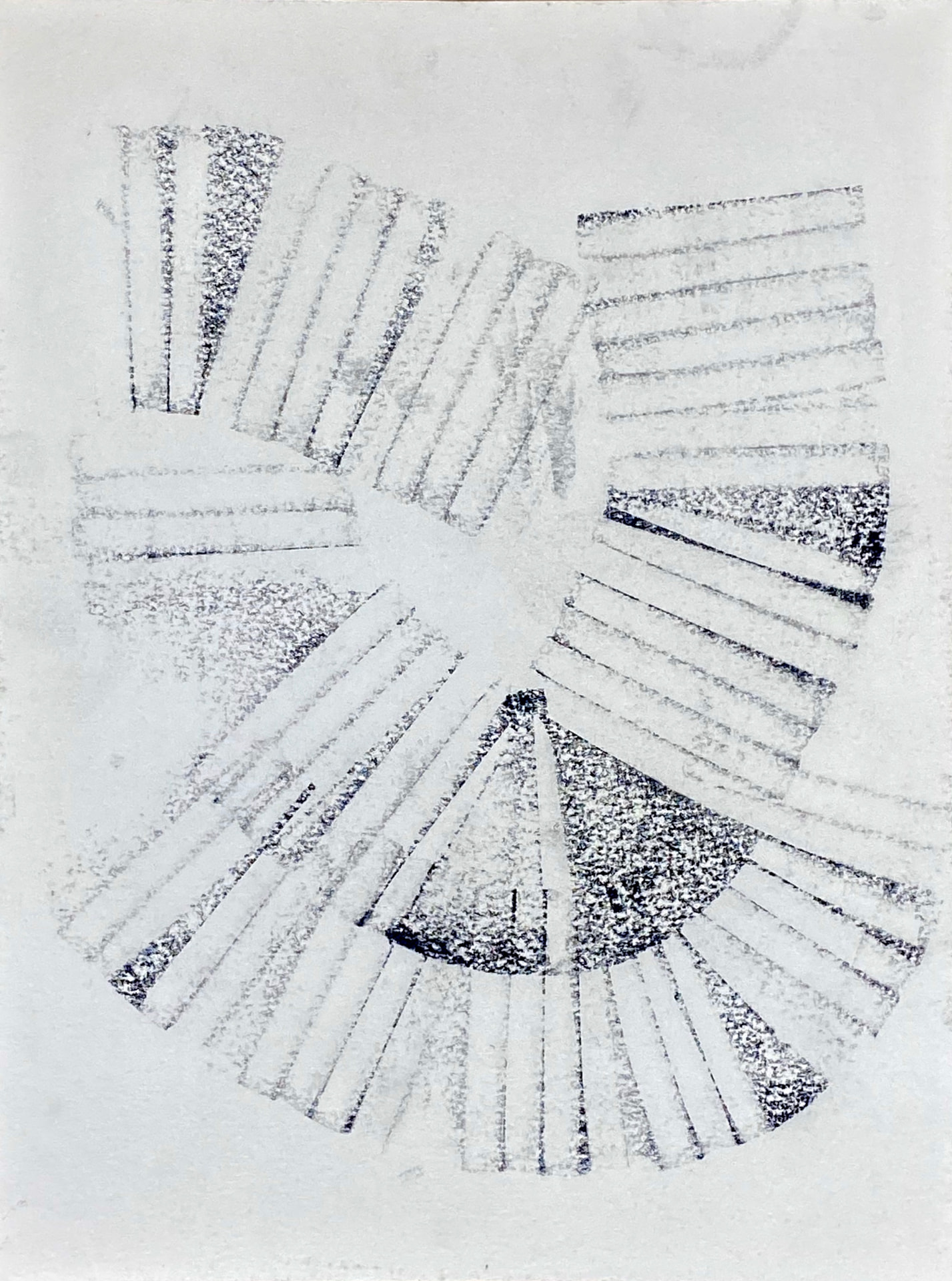 Pale charcoal impressions radiating around an open center on white paper