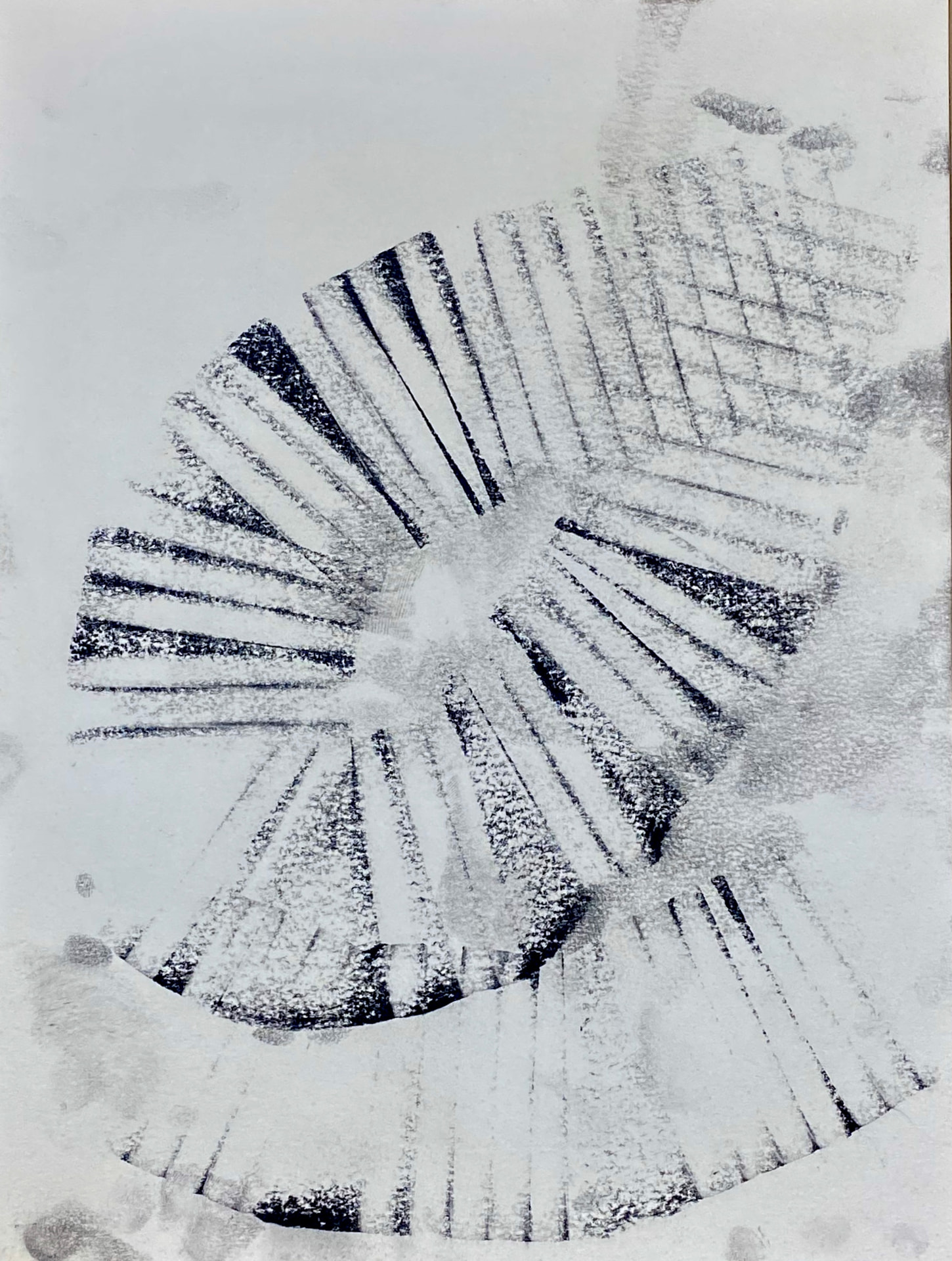 Black charcoal marks repeating in a loose spiral on white paper